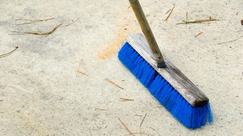 Sweeping concrete with broom